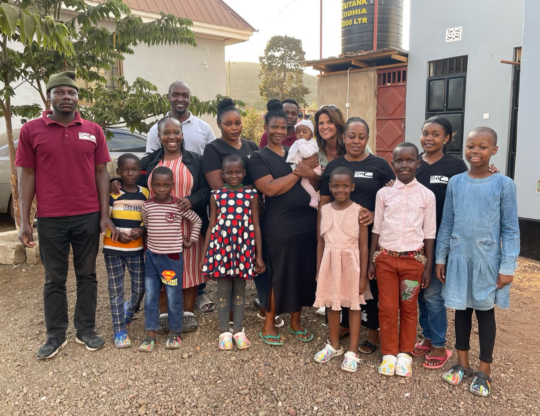 The children, staff and visitors of Holley Children Orphanage standing together in front of the house in Arusha.